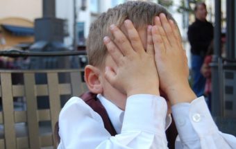 Мальчик закрыл лицо